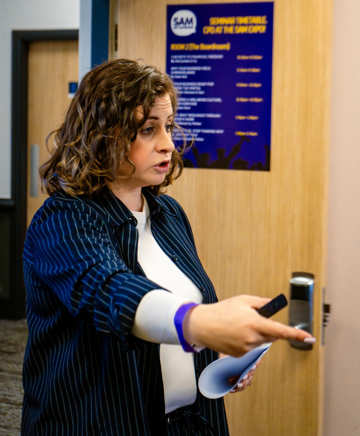 Kate Keir mid-presentation, gesturing as she engages with the room.